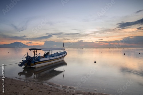 Sanur beach in the morning at Bali, Indonesia with traditional balinese fishing boat
