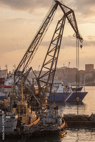 floating crane moored in the port of Vladivostok in the evening