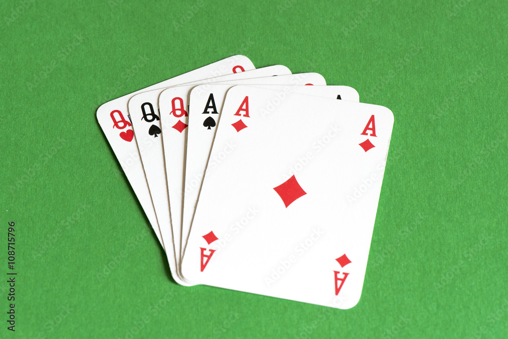 Fototapeta premium Playing card on green table, Full house