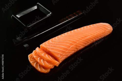 Fresh salmon fillet on black background