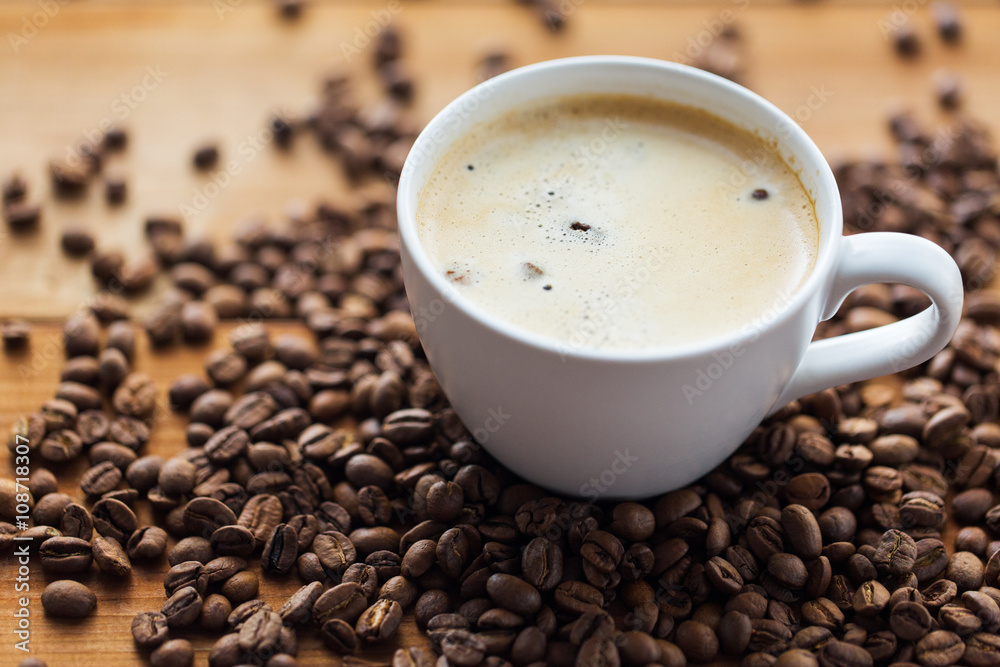 close up coffee cup and grains on wooden table close up coffee cup and grains on wooden table