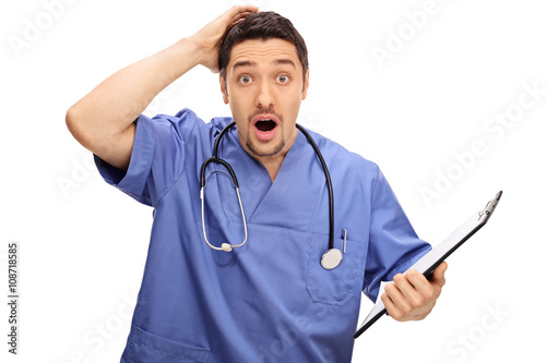 Surprised young doctor in blue uniform