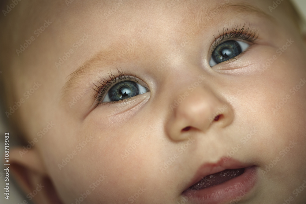 Portrait of a baby girl with amazing blue eyes with an opened mo Portrait of a baby girl with amazing blue eyes with an opened mo