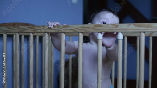 Sweet baby playing in a crib
 photo