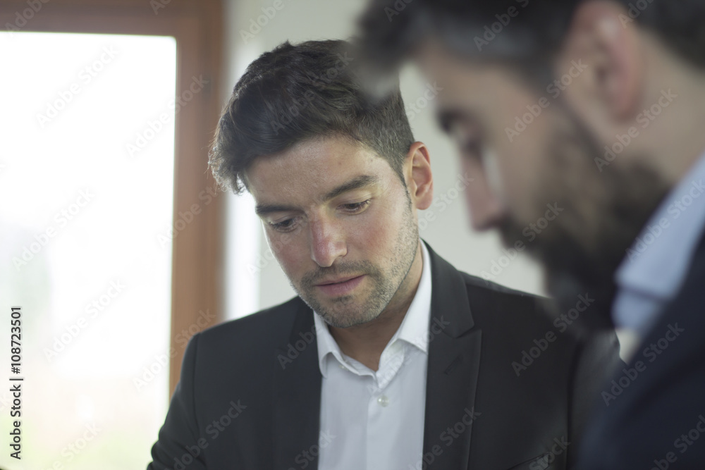Close-up view of young worker man during a business meeting. Close-up view of young worker man during a business meeting.