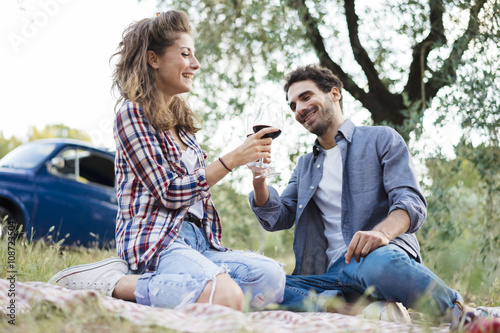 Young couple in love doing a picnic outdoors in Tuscany wine country © juripozzi