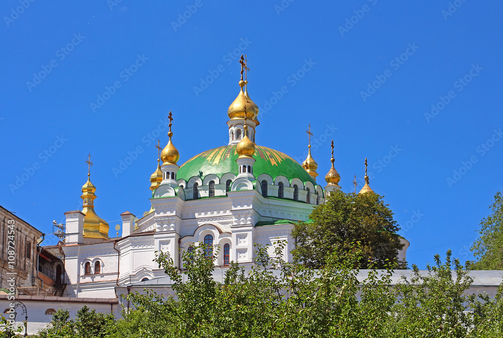 Orthodox domes with golden crosses of the Refectory church and the Assumption cathedral of Kyiv Pechersk Orthodox monastery in Kyiv, Ukraine