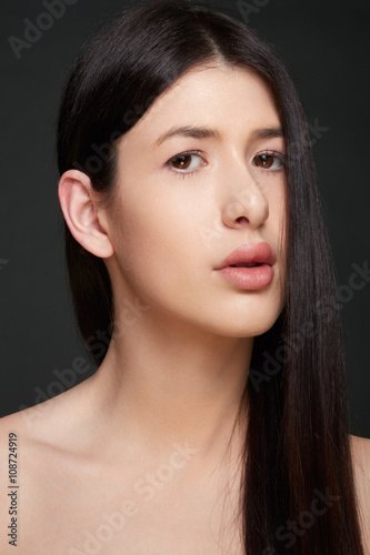 Young woman portrait with natural make up and dark straight hair