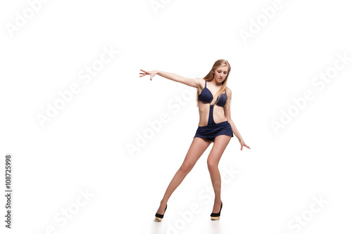Fototapeta Naklejka Na Ścianę i Meble -  Young beautiful dancer posing on studio background