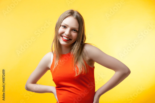 Fashionable young woman in orange dress 