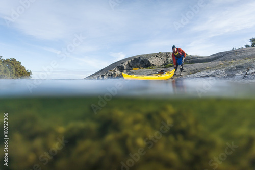 Person with kayak at sea