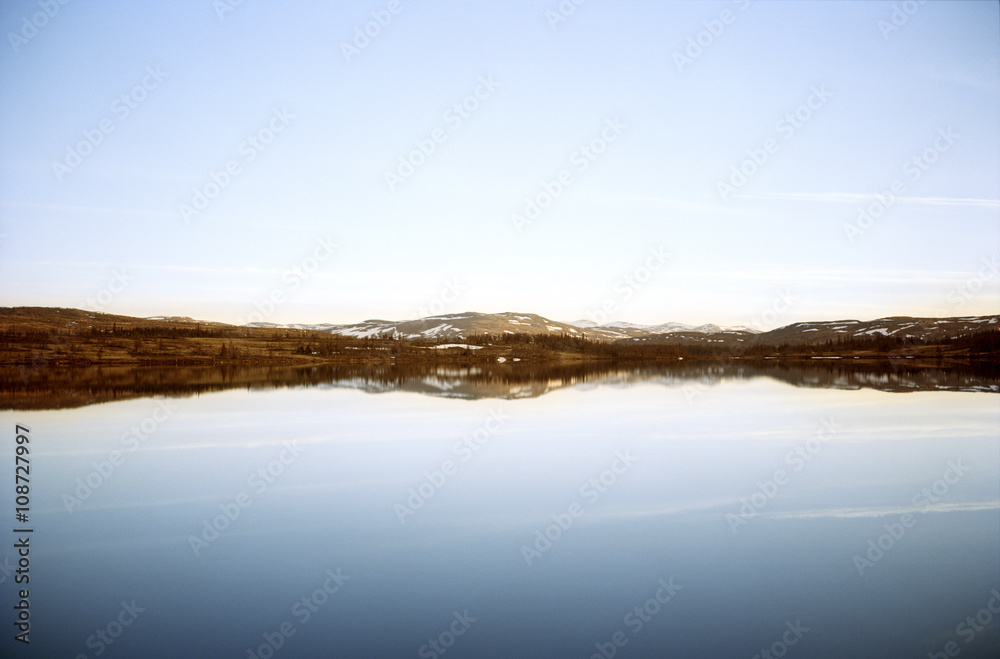 Mountains and sky reflecting in water Mountains and sky reflecting in water