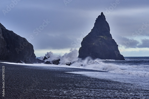 Famous Reynisdrangar rock formations at black Reynisfjara Beach. Coast of the Atlantic ocean near Vik, nature