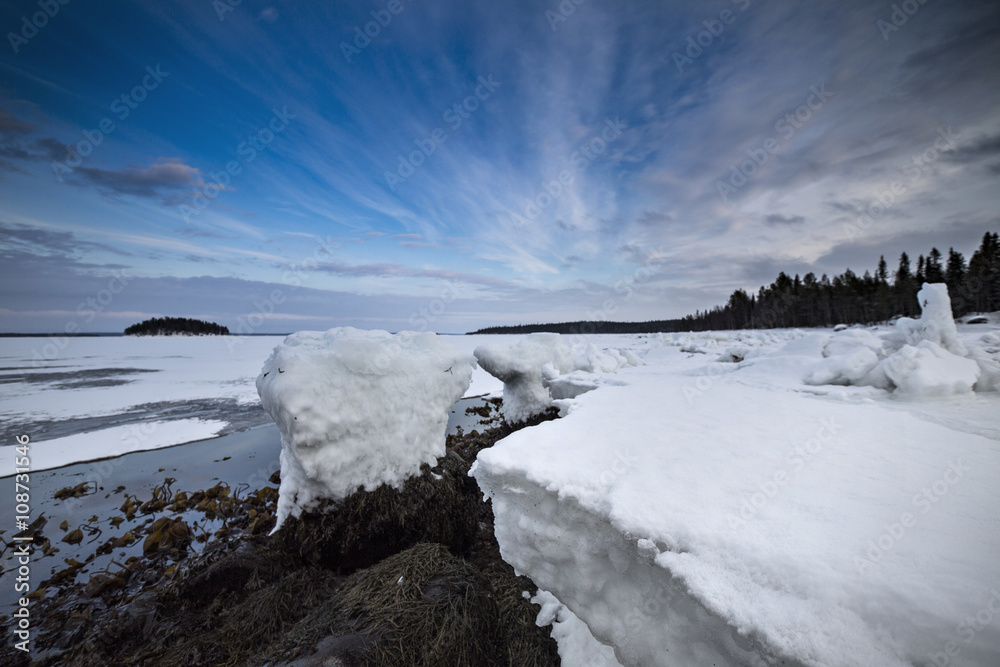 Winter shore of White Sea under the wonderful sky. Northern Karelia. Russia.