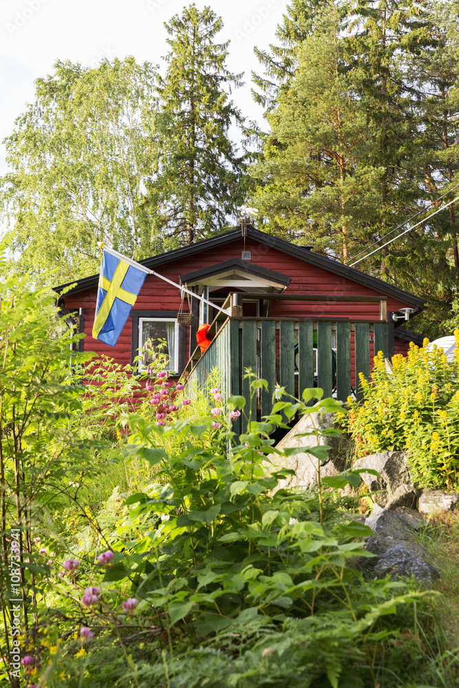 Wooden house with Swedish flag Wooden house with Swedish flag
