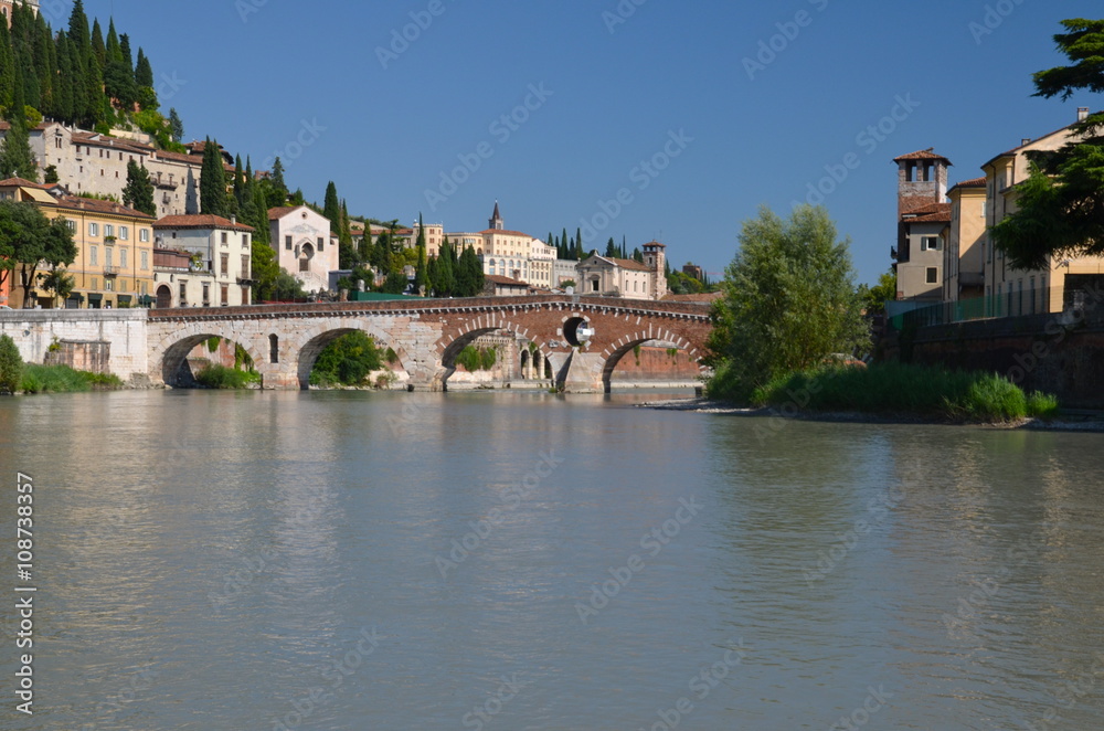 Ponte Pietra on river Adige, ancient roman bridge in the old town of Verona, Italy
