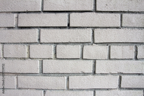 Wall of white brick. Background of white bricks. Texture of brick wall close. Sturdy wall of a building. The bricks are laid manually. Manual brickwork walls during construction.