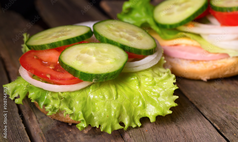 Sandwich with salad and other vegetables on old gray boards Sandwich with salad and other vegetables on old gray boards