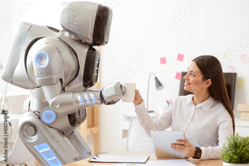Robot giving cup of coffee to the girl 