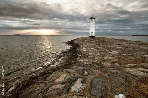 Lighthouse windmill Stawa Mlyny in Swinoujscie, Baltic Sea, Poland. photo