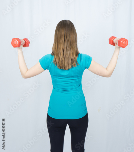 girl with dumpbells sport concept gym