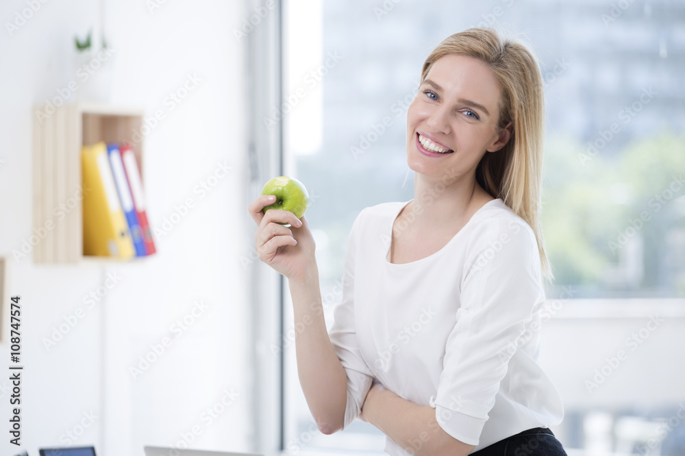 Business woman having healthy snack, eating apple Business woman having healthy snack, eating apple