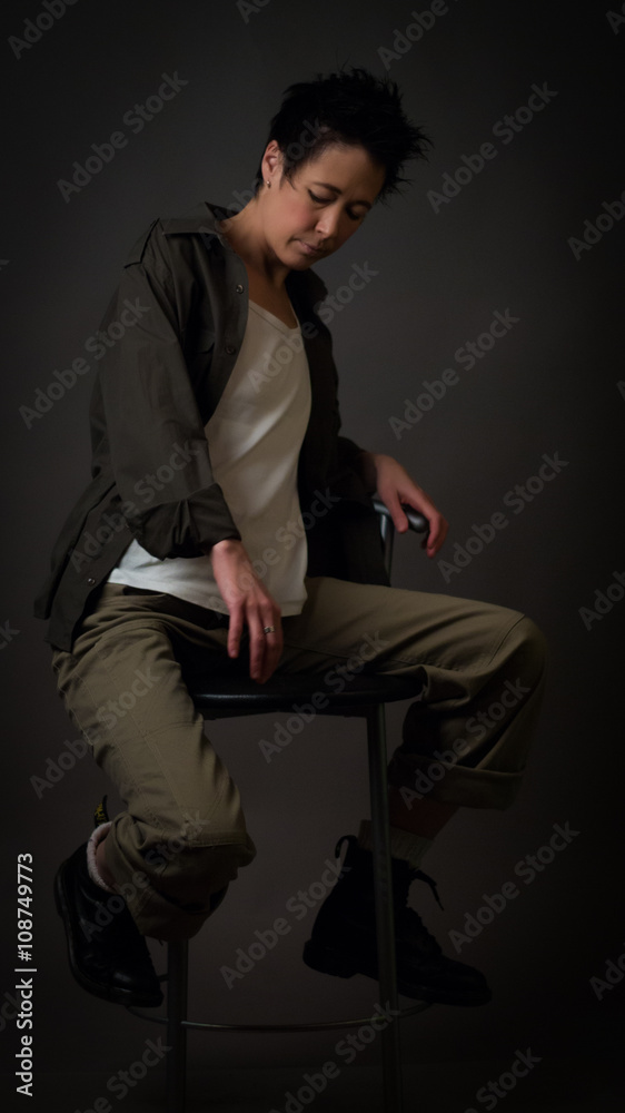 Androgynous character on a gray background. Man or woman. Military style. Androgynous character on a gray background. Man or woman. Military style.
