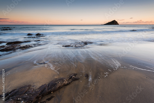 Red rocks on beach in Wembury, Devon, UK photo