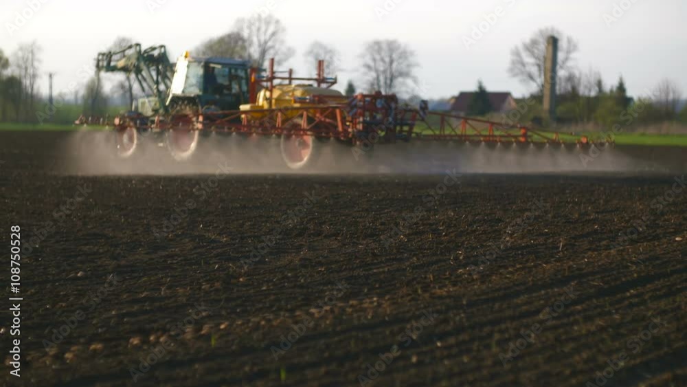 Tractor spray fertilize on field with chemicals in agriculture field. Tractor spray fertilize on field with chemicals in agriculture field.