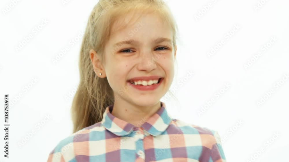 Closeup portrait laughing child girl looking at camera on the white background