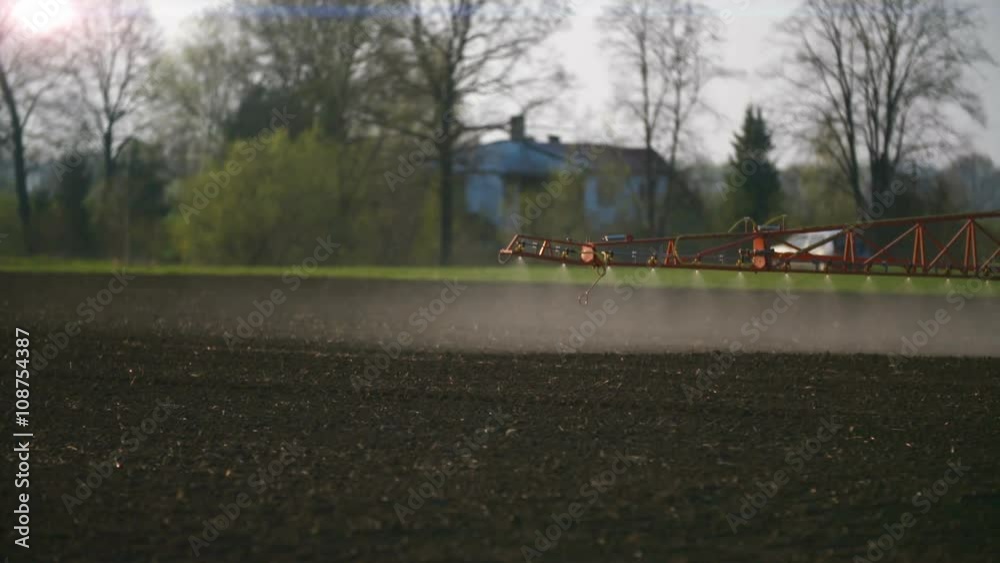 Tractor spray fertilize on field with chemicals in agriculture field. Tractor spray fertilize on field with chemicals in agriculture field.