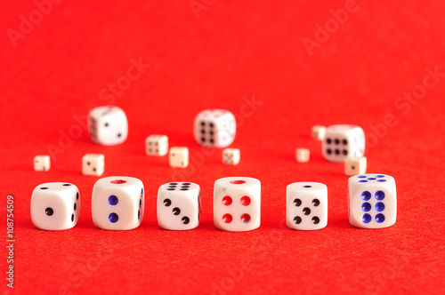 A collection of dice on a red background