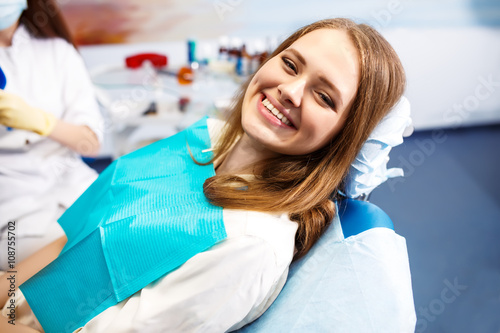 Overview of dental caries prevention.Woman at the dentist s chair during a dental procedure. Beautiful Woman smile close up. Healthy Smile. Beautiful Female Smile  