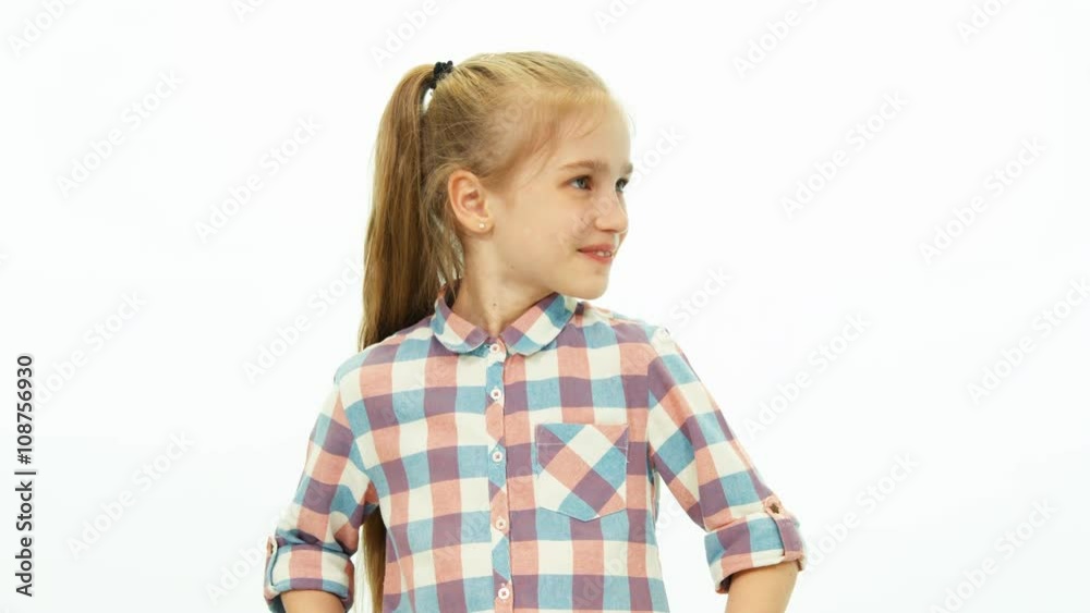 Portrait cute girl in the shirt standing on the white background and smiling at camera. Thumb up. Ok Portrait cute girl in the shirt standing on the white background and smiling at camera. Thumb up. Ok
