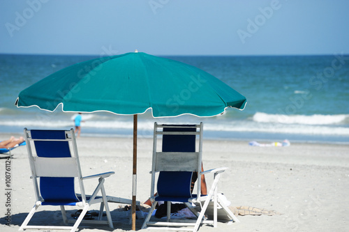 Fototapeta Naklejka Na Ścianę i Meble -  beach umbrella and chairs in summer