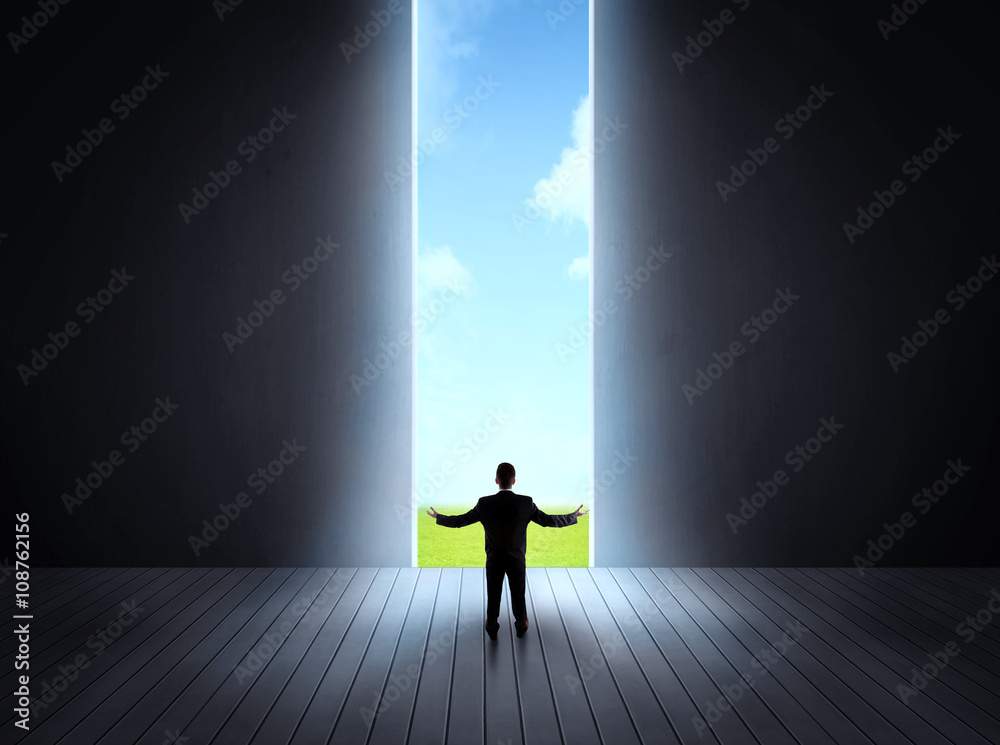 businessman walking to open gate businessman walking to open gate