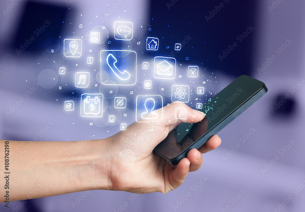Hand holding smartphone with mobile app icons Hand holding smartphone with mobile app icons