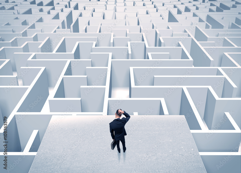 Businessman staring at infinite maze Businessman staring at infinite maze