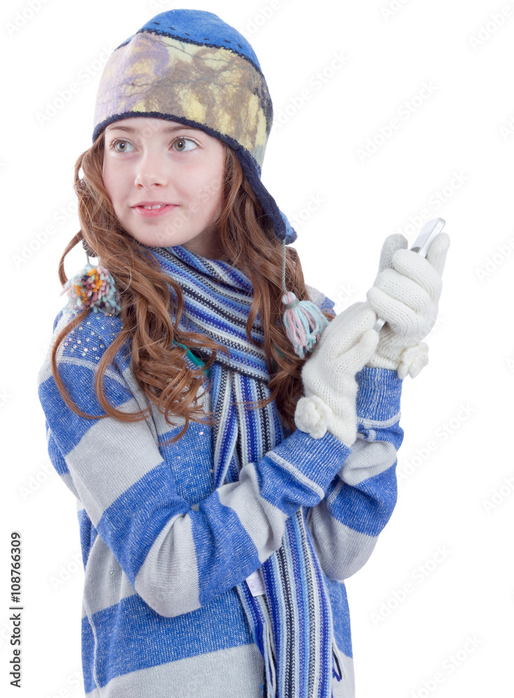 Pretty teen girl in winter clothes with smartphone Pretty teen girl in winter clothes with smartphone
