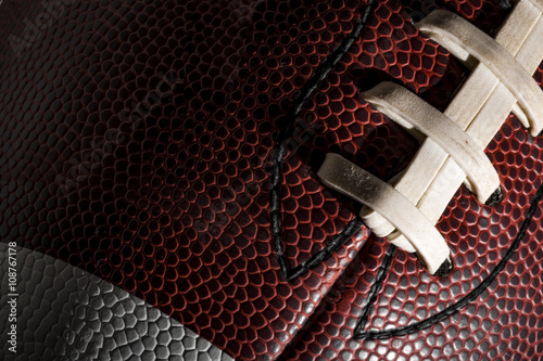Macro of a american football ball with visible laces, stitches and pigskin pattern