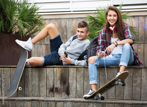 Teenage relaxing with mobile phones