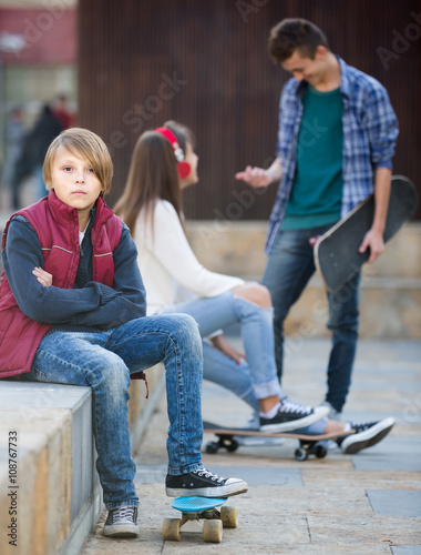 teen and his friends after conflict outdoors