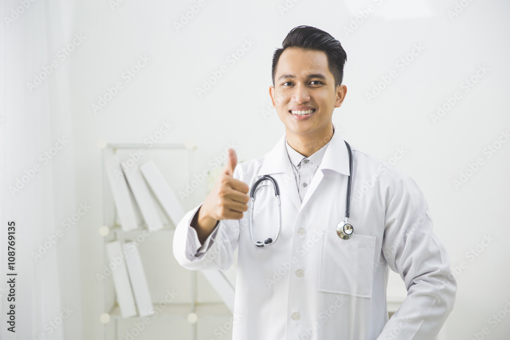 friendly doctor smiling giving thumbs up friendly doctor smiling giving thumbs up