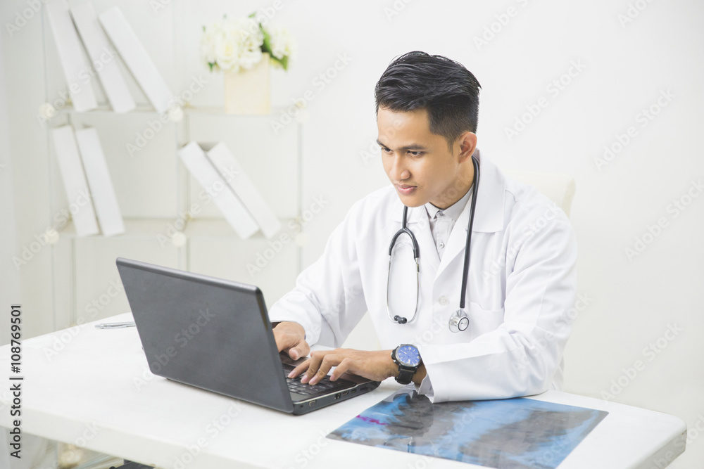 Medical doctor working with laptop in the office Medical doctor working with laptop in the office