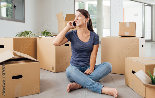 Woman on the phone in her new house © stokkete