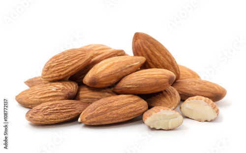Heap of almond nuts isolated on white background