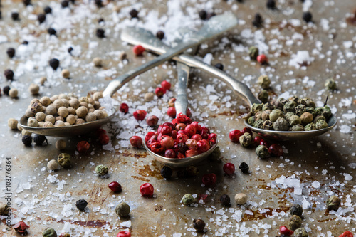 Photos peppercorn seeds on vintage spoons