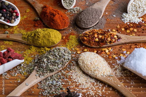 Fototapeta Naklejka Na Ścianę i Meble -  diferent color spices on wooden table