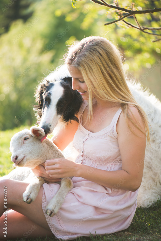 Farm life. Blonde farmer woman playing with Borzoi dog and baby lamb. Farm life. Blonde farmer woman playing with Borzoi dog and baby lamb.