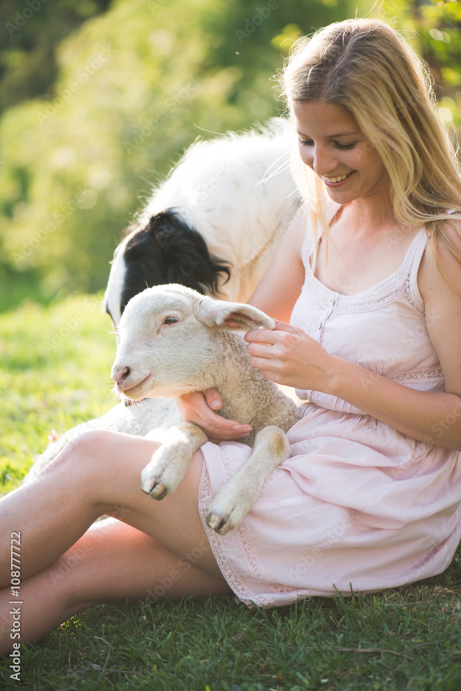 Farm life. Blonde farmer woman playing with Borzoi dog and baby lamb. Farm life. Blonde farmer woman playing with Borzoi dog and baby lamb.